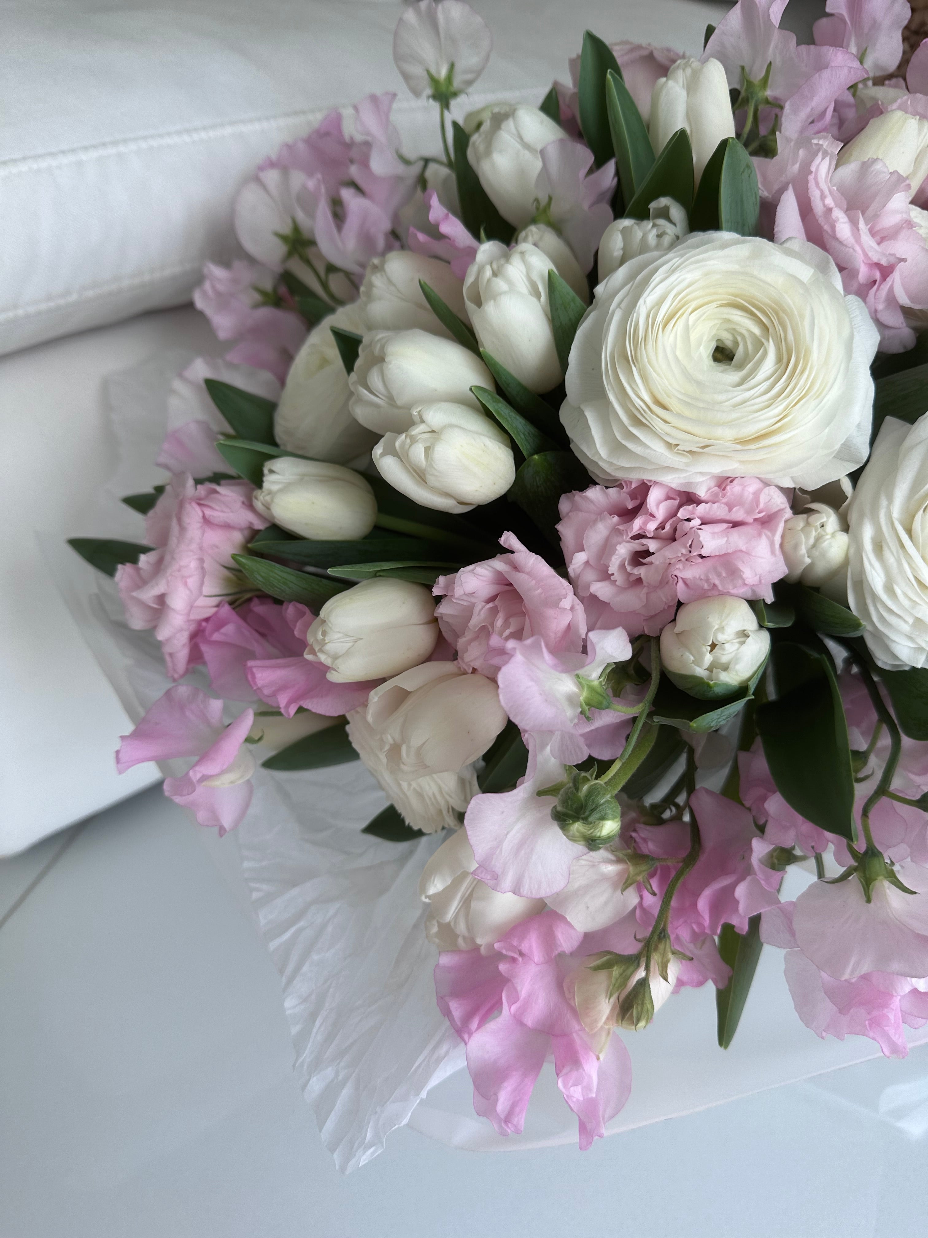 Pink charm - Beautiful bouquet of delicate spring tulips, ranunculus, lisianthus and sweet peas.