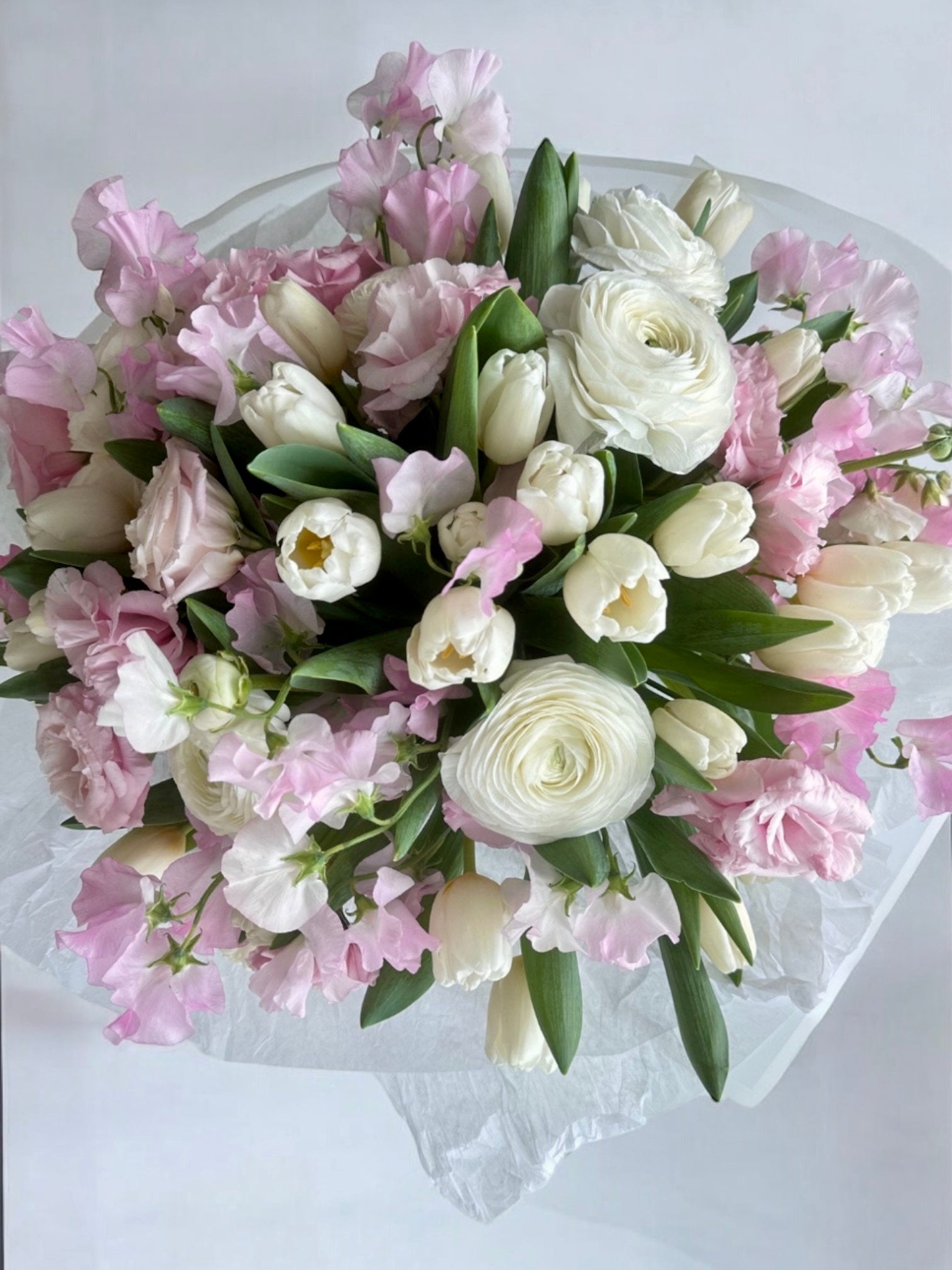 Pink charm - Beautiful bouquet of delicate spring tulips, ranunculus, lisianthus and sweet peas. - Maison la Fleur