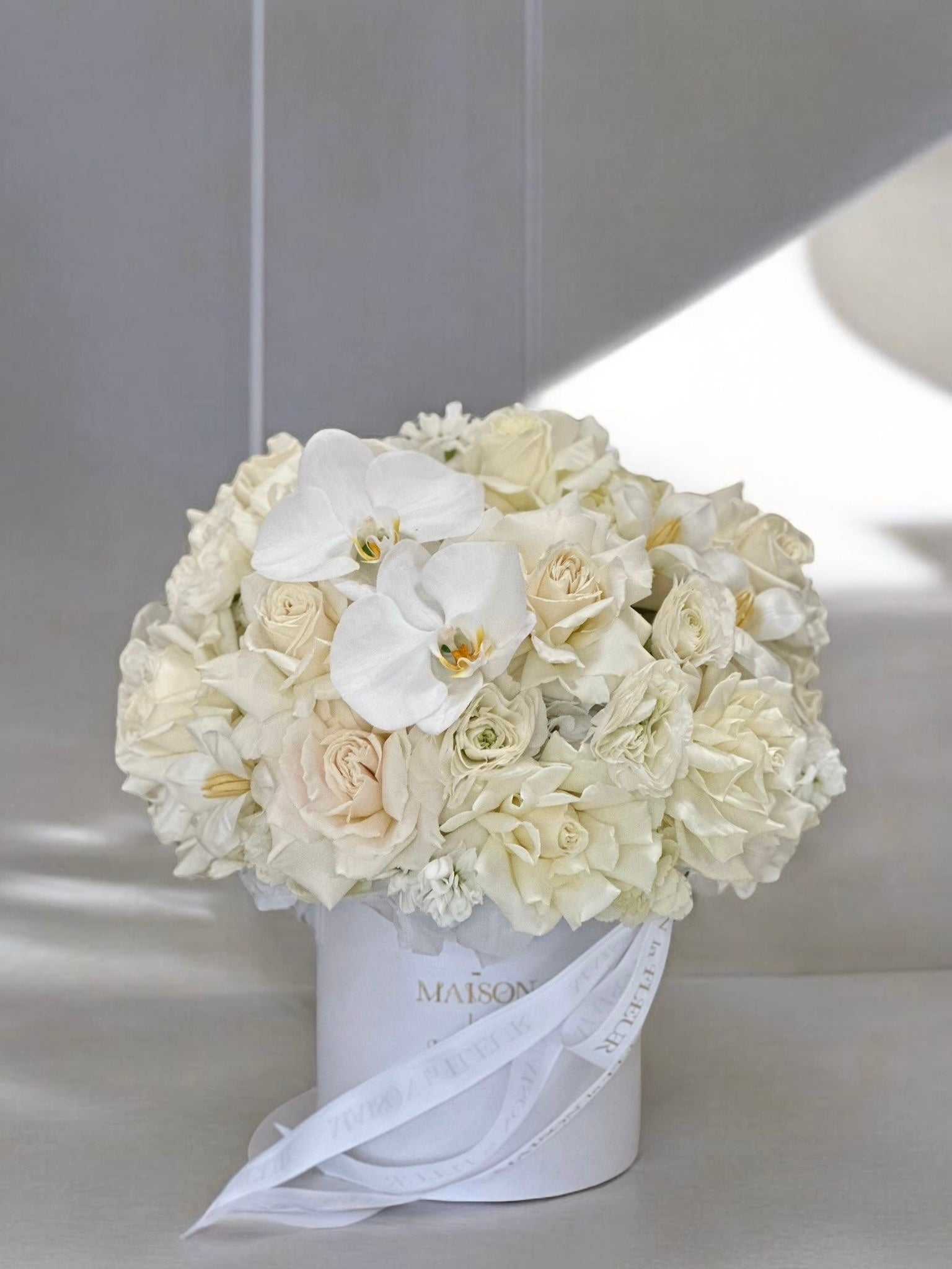 White Butterfly - Beautiful arrangement in a box with premium long stem white roses, hydrangea, ranunculus and freesia - Maison la Fleur